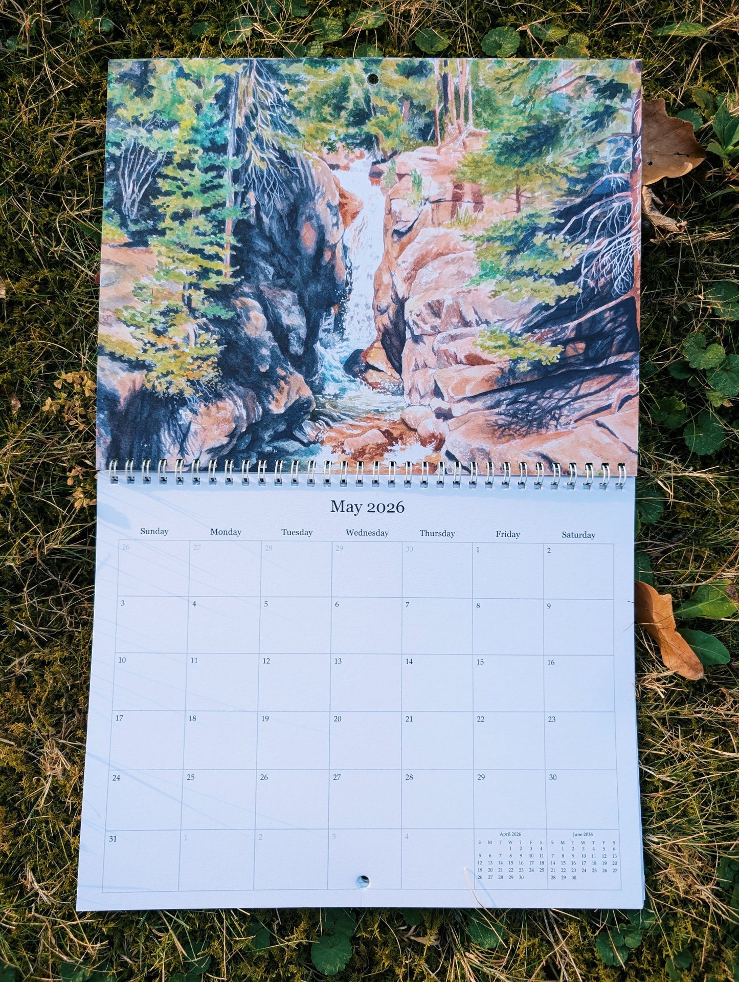 Calendar with a nature-themed cover showing a waterfall