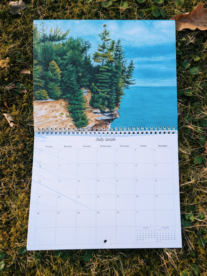 Calendar with a scenic design of trees on a rocky cliff over water