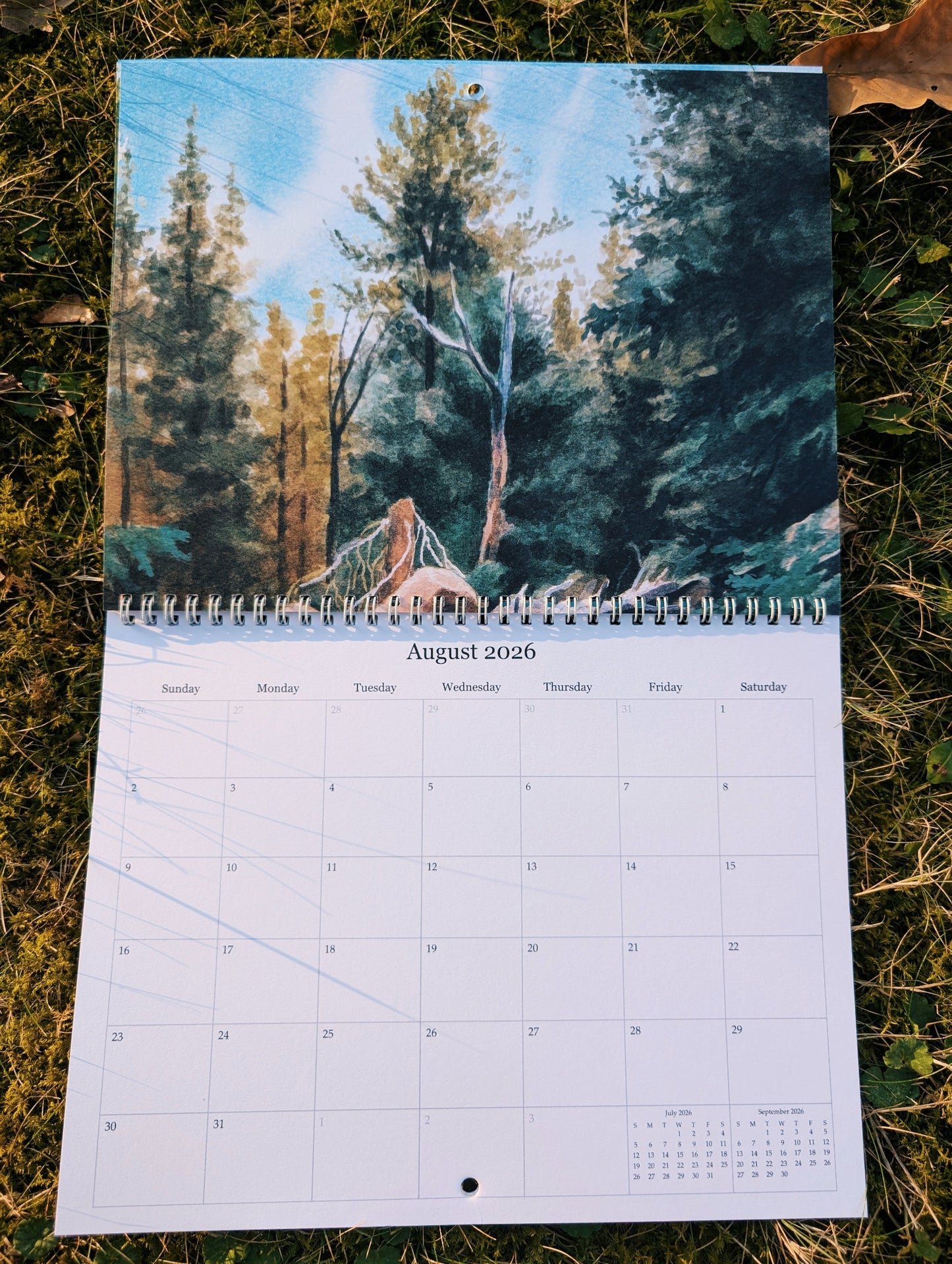 Calendar with a forest design on grass